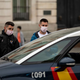 Spanish police in Madrid stop two pedestrians to tell them about the new coronavirus measures on March 15. Spain’s prime minister issued a national lockdown on March 14.